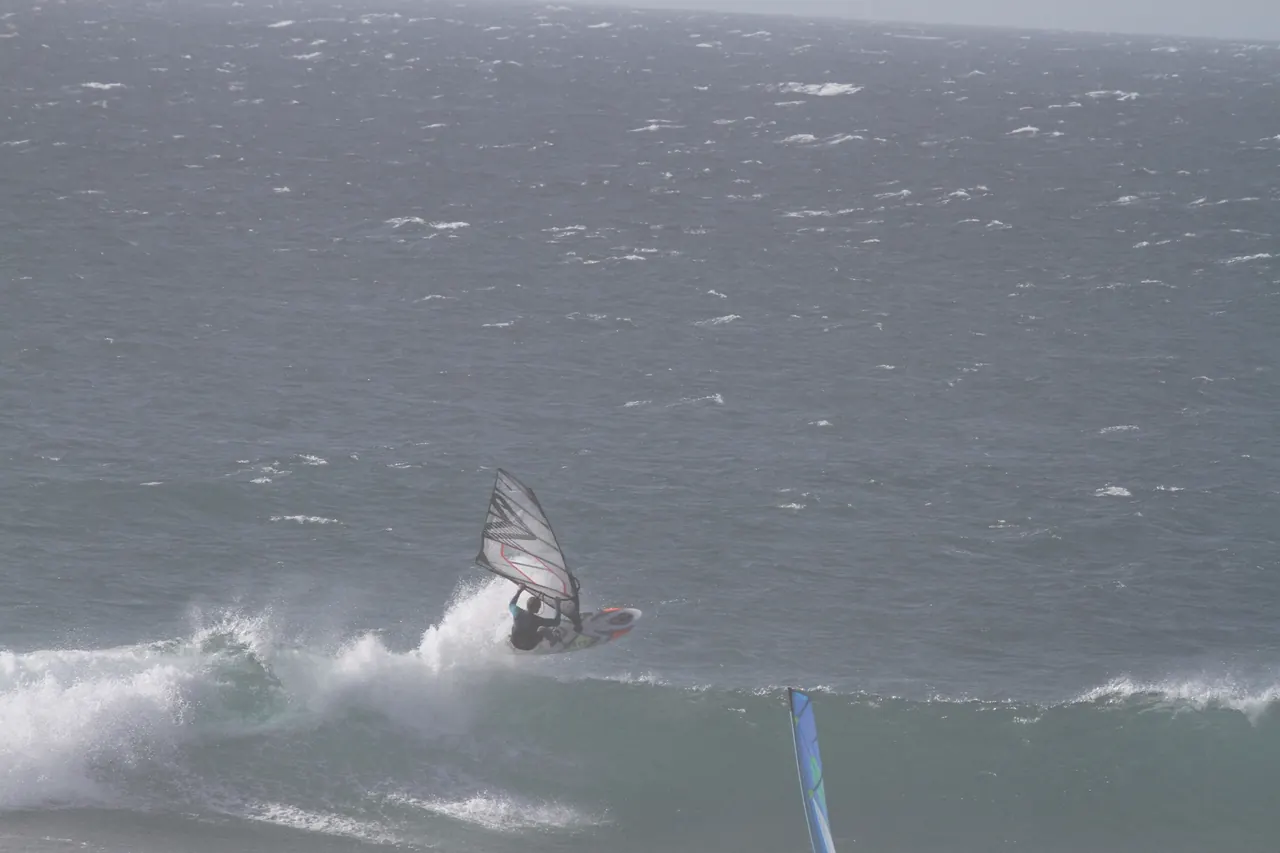 Windsurfer rijdt de golf af